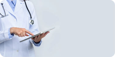 A person dressed in a doctor's white coat and a stethoscope around its neck is holding and pointing to a clipboard.