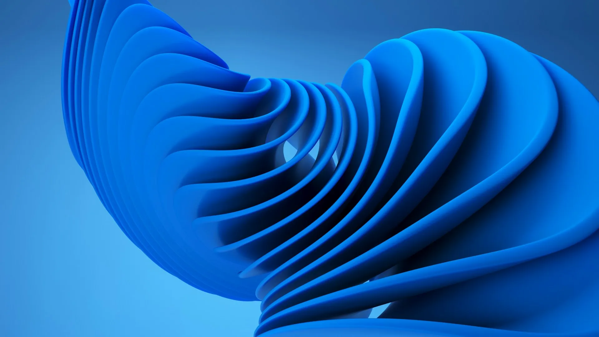 A blue object with an abstract design made of swirling petals.