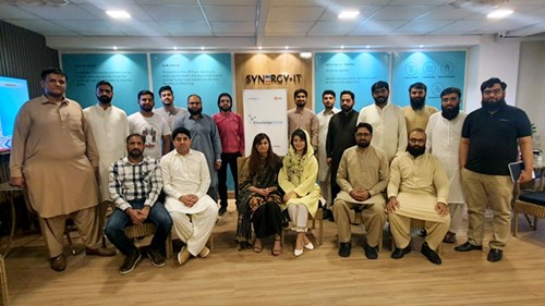 A group of people are posing for a picture after a training.